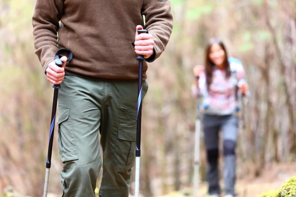 A man hiking in the fall. Men's gardening pants can be pants that are sold for other outside activities such as hiking/ fishing, or construction.