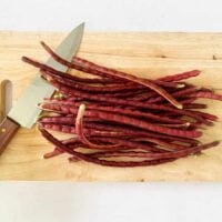 Red yardlong beans on a cutting board